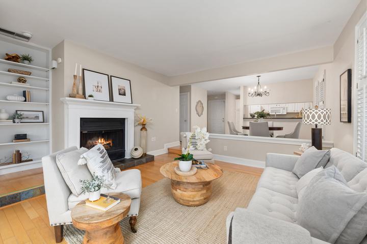 White fireplace and pale seating in a bright living room